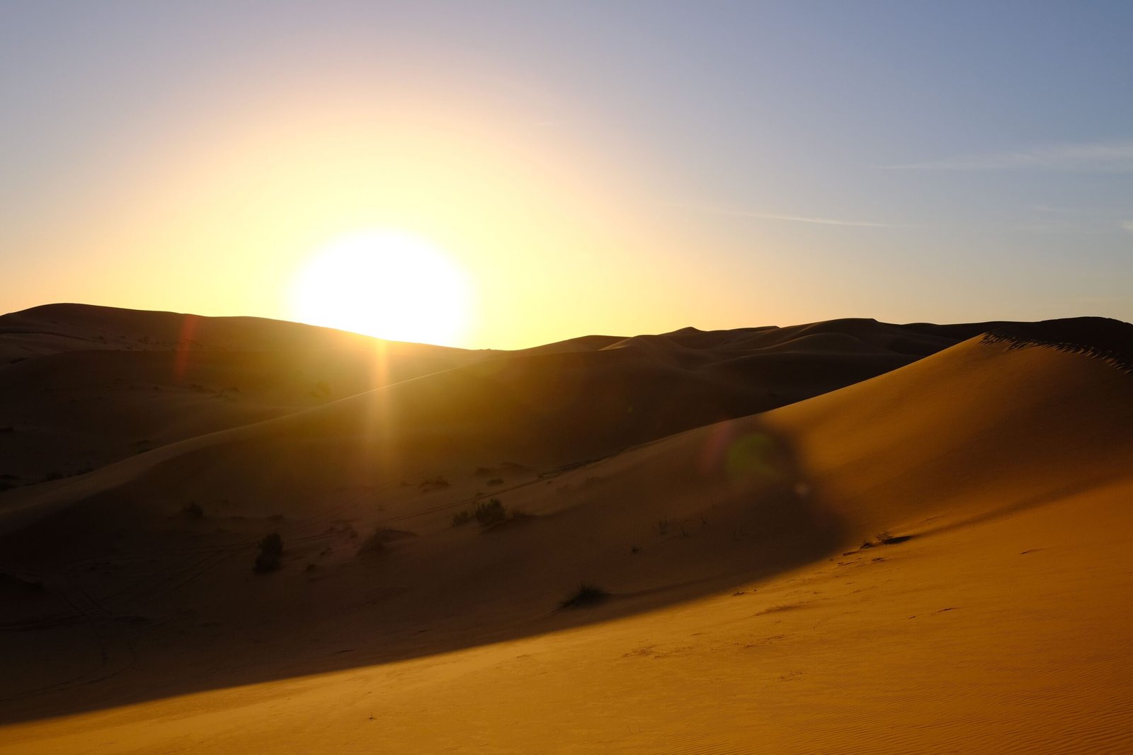 Beautiful sunrise over sand dunes in the Egyptian desert, New Valley Governorate.