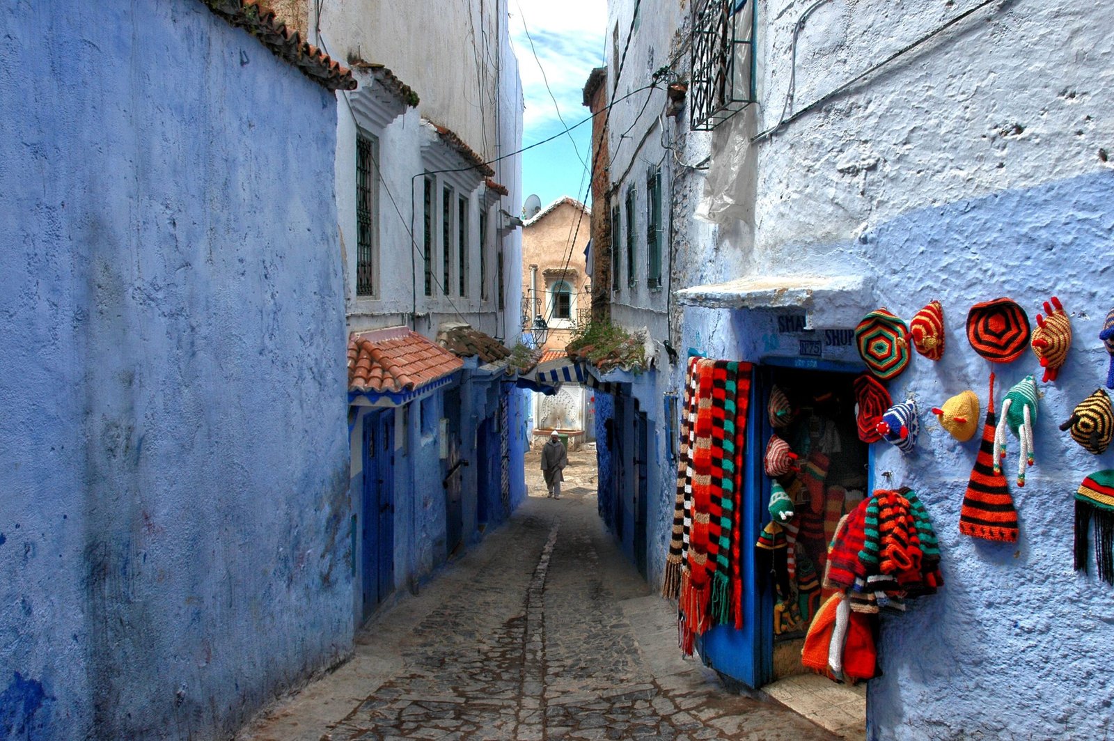 Vibrant colors and traditional crafts in the iconic blue-washed streets of Chefchaouen, Morocco.