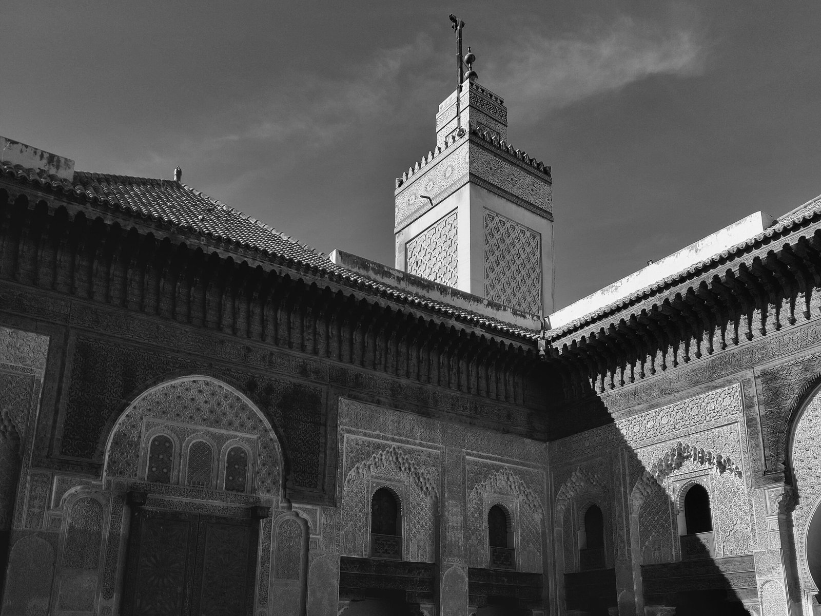 Black and white capture of traditional Moroccan structure, showcasing detailed Islamic architecture in Fes.