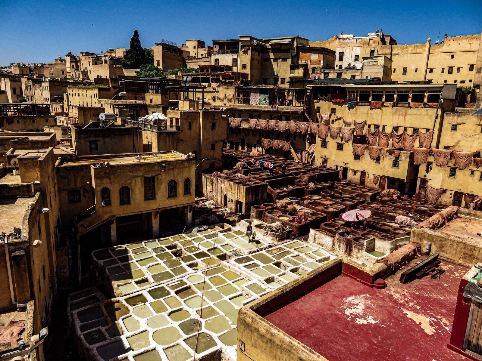 Aerial view of the iconic Fez tannery in the historic medina, showcasing vibrant dye vats.